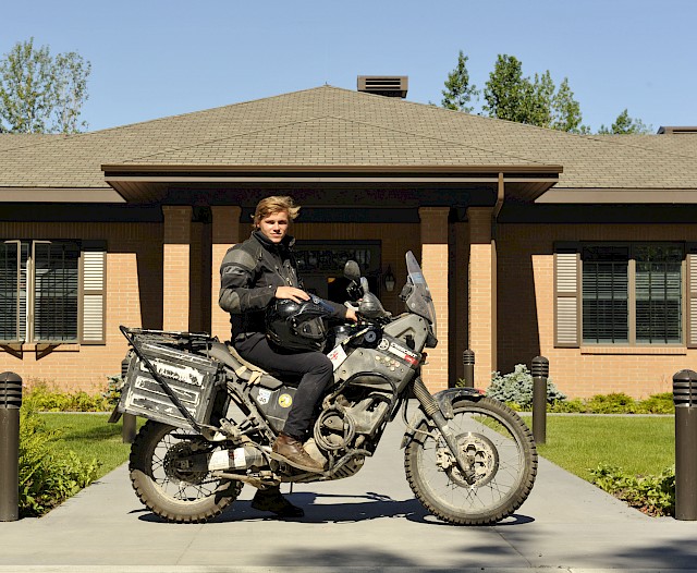 7/22/2013 - JOINT BASE ELMENDORF-RICHARDSON, Alaska--Oliver Plunket, 18-year-old native of the United Kingdom, stops at the Fisher House of Alaska on Joint Base Elmendorf-Richardson July 22. Plunket took a gap year between high school and college to travel as a way to raise money for the newly built Fisher House in the UK. His goal was to raise $150,000 but at the end of his travel he raised $89,000, which will all go to the newly built Fisher House. He rode his motorcycle from Argentina to Prudhoe Bay, Alaska, stopping to volunteer at other Fisher Houses and visiting various historic sites. (U.S. Air Force photo/Airman 1st Class Tammie Ramsouer)